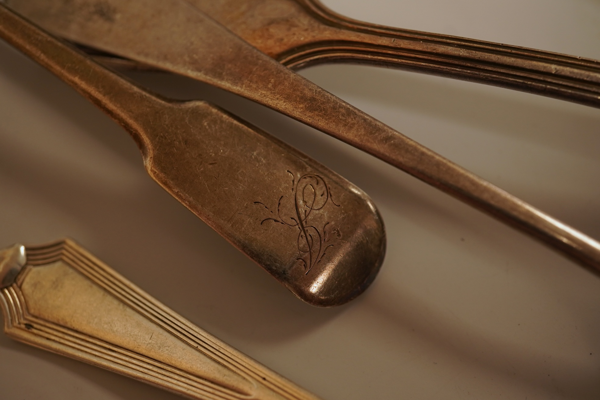A small quantity of 18th century and later assorted silver teaspoons, various patterns, dates and makers, together with a George V silver pastry fork and two George V silver caddy spoons, 10.7oz.